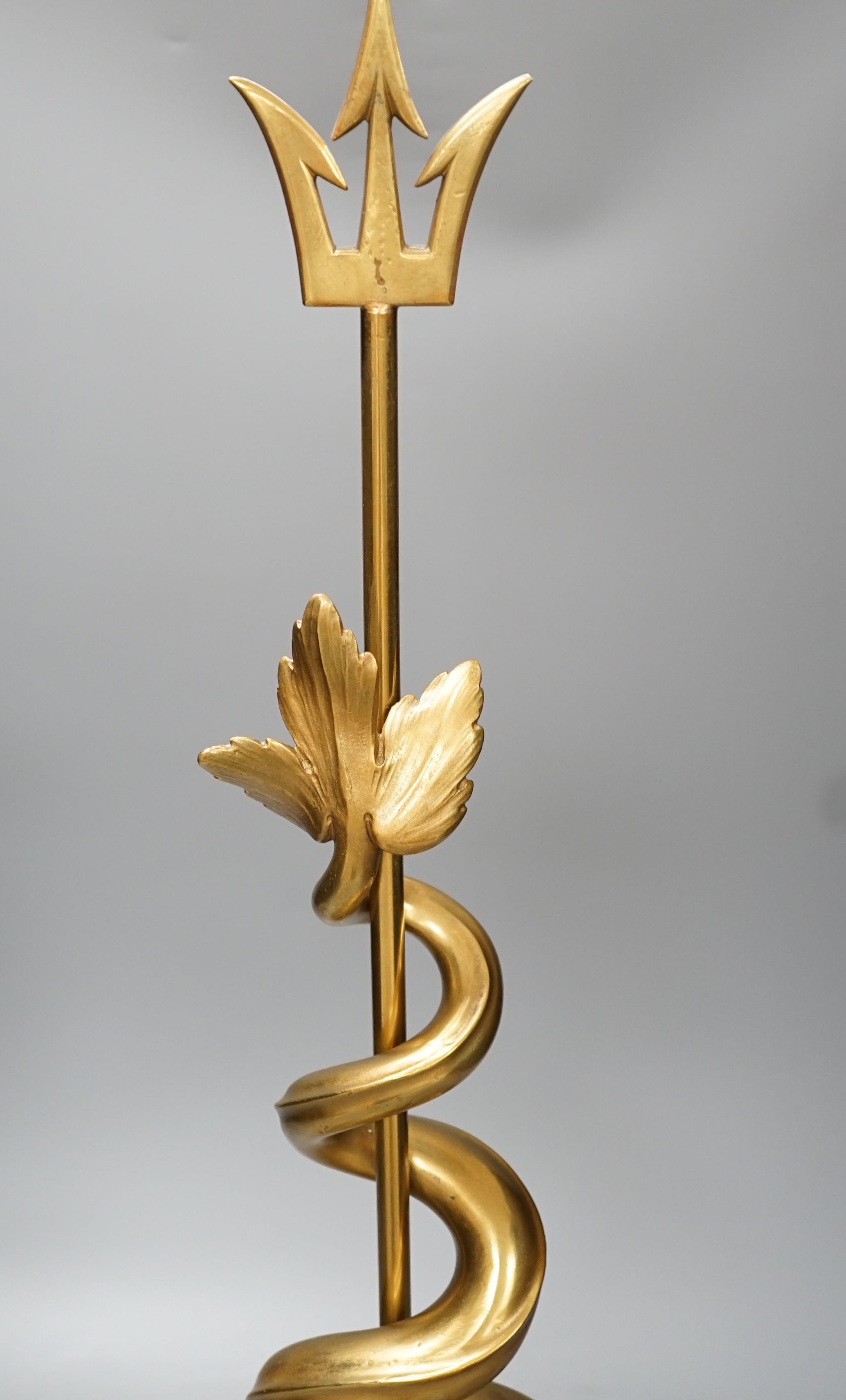 A gilt brass dolphin and trident door porter - 69cm high